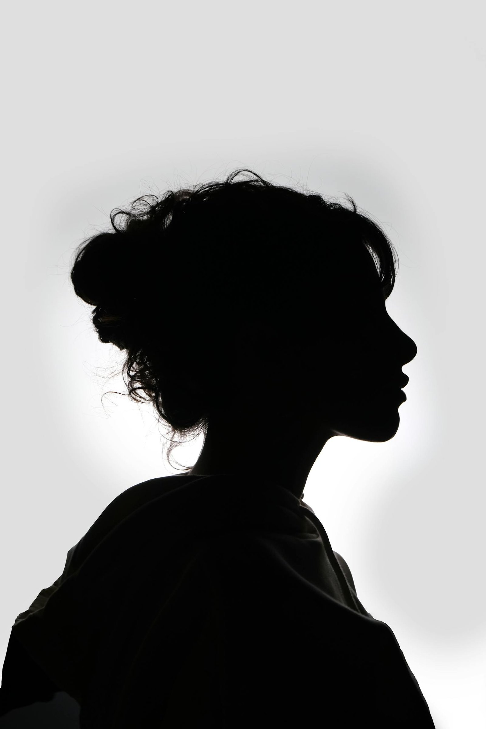Striking black and white silhouette of a woman in profile, showcasing graceful features.